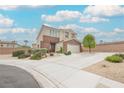 Lovely two-story home with a wide driveway, two-car garage, and well-manicured front yard at 9373 Oxbow Lake Ave, Las Vegas, NV 89149