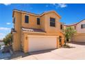 Two-story home featuring a two car garage, neutral stucco, and a red tile roof at 10457 Armand Ave, Las Vegas, NV 89129