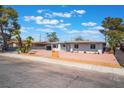 Inviting single-story home featuring well-maintained landscaping, mature trees, and a neatly kept exterior at 1202 Arrowhead Ave, Las Vegas, NV 89106