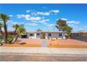 Charming single-story home with desert landscaping, vibrant curb appeal, and a welcoming yellow front door at 1202 Arrowhead Ave, Las Vegas, NV 89106