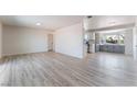 Open-concept living room featuring light, neutral walls and floors, seamlessly connecting to an updated kitchen at 1202 Arrowhead Ave, Las Vegas, NV 89106