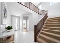 Bright foyer showcasing marble floors, a staircase with wood railings, and an open view to the bedroom at 1212 Crimson Sunbird St, North Las Vegas, NV 89084
