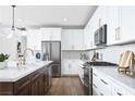 Beautiful kitchen featuring white cabinets, stainless steel appliances, an island with seating, and modern countertops at 1212 Crimson Sunbird St, North Las Vegas, NV 89084