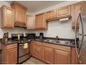 A kitchen featuring wood cabinets and stainless steel appliances at 1553 Dorothy Ave # 4, Las Vegas, NV 89119