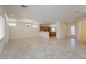 Bright living room with tile flooring, crown molding, and an open layout flowing into the kitchen at 2163 Bannerwood St, Henderson, NV 89044