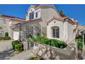 Charming stucco home with a gated walkway and lush landscaped front yard at 2212 Warm Walnut Dr, Las Vegas, NV 89134