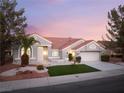 Charming single-story home featuring a well-manicured lawn and desert landscaping at 2528 Sunup Dr, Las Vegas, NV 89134