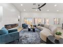 Bright living room with modern fireplace, recessed lighting, and a large curved sofa at 2528 Sunup Dr, Las Vegas, NV 89134