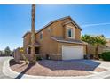 A two-story home with desert landscaping and a two-car garage, accented by palm trees at 2608 Los Palos St, Las Vegas, NV 89108