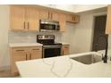 Close-up shot of kitchen showcasing quartz countertops, updated appliances and cabinets at 2615 W Gary Ave # 1015, Las Vegas, NV 89123