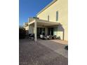 Covered back patio with brick pavers, outdoor seating and a grill at 3216 Waterstone Ave, Henderson, NV 89044