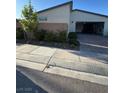 Single story home featuring an attached garage and a nicely landscaped exterior at 3216 Waterstone Ave, Henderson, NV 89044