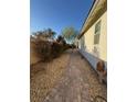 Narrow side yard featuring a stone path and minimal landscaping at 3216 Waterstone Ave, Henderson, NV 89044