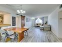 Sunlit open concept living space with whitewashed floors, dining area, and comfortable seating at 3930 University Center Dr # 409, Las Vegas, NV 89119