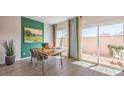 Stylish dining area with a view to the outside, modern furniture, and a slider door to the patio at 4754 Bluebird Cliffs Ave Dr # Lot 170, Las Vegas, NV 89141