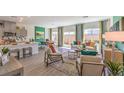 Bright living space with modern decor, wood-look floors, and a view of the backyard, perfect for entertaining at 4754 Bluebird Cliffs Ave Dr # Lot 170, Las Vegas, NV 89141