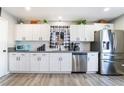 Bright kitchen with white cabinets, gray countertops, and stainless steel refrigerator at 4786 San Rafael Ave, Las Vegas, NV 89120