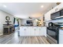 Modern kitchen with white cabinets, stainless steel appliances, and an open layout at 4786 San Rafael Ave, Las Vegas, NV 89120