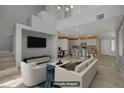 Open-concept living room showcasing an eat-in kitchen with stainless steel appliances and tiled floors at 4972 Groveland Ave, Las Vegas, NV 89139