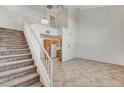 Open-concept living area features tile floors, high ceilings, and staircase leading to the second floor at 5588 Ness Ave, Las Vegas, NV 89118