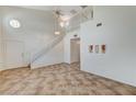 Spacious living area features tile flooring, high ceilings, and a staircase leading to the second floor at 5588 Ness Ave, Las Vegas, NV 89118