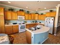 Spacious kitchen with island and white appliances at 5772 Flying Birdie Ave, Las Vegas, NV 89122