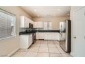 Clean kitchen featuring stainless steel appliances, white cabinets, and granite countertops at 5921 Royal Castle Ln, Las Vegas, NV 89130
