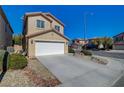 Two-story home with a two-car garage, desert landscaping, and a tidy appearance at 6424 Bombax Ct, Las Vegas, NV 89141