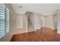 Inviting living room featuring hardwood floors, neutral paint, and staircase at 6424 Bombax Ct, Las Vegas, NV 89141
