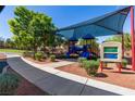 Fun playground with slides and climbing structures under a shaded canopy, providing a safe and enjoyable play area at 7237 Puddle Duck St, Las Vegas, NV 89166