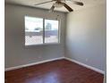 Bedroom featuring wood flooring, a large window, and a ceiling fan at 805 Slayton Dr, Las Vegas, NV 89107