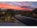 Scenic street view with a stunning sunset backdrop, highlighting the desirable neighborhood and peaceful surroundings at 9 Chalet Hills Ter, Henderson, NV 89052
