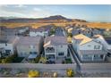 Community aerial view of homes nestled in a desert landscape with mountains in the distance at 10031 Fletcher Peak Ave, Las Vegas, NV 89178