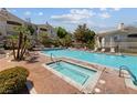 Community pool and spa area with lounge chairs and well-maintained landscaping at 10116 Jacob Pl # 104, Las Vegas, NV 89144