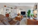 Comfortable living room featuring neutral walls, two sofas, wooden coffee table, and plants at 1658 Autumn Rust Dr, Las Vegas, NV 89119