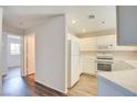 Well-lit kitchen featuring white appliances and a view into an adjacent room at 1979 Cutlass Dr # 1979, Henderson, NV 89014