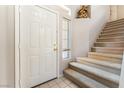 Inviting entryway with carpeted stairs, tile floor, and a charming niche at 4708 Grand Rock Dr, North Las Vegas, NV 89081