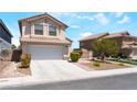Lovely home featuring a two-car garage, a tile roof, and desert landscaping at 4708 Grand Rock Dr, North Las Vegas, NV 89081