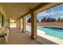Outdoor pool area features a covered patio with tiled flooring and ample seating at 5300 E La Terra Ave, Pahrump, NV 89061
