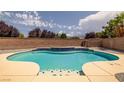 Inviting pool area featuring a sparkling pool with blue tile accents and a brick privacy wall at 5300 E La Terra Ave, Pahrump, NV 89061