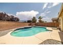 Inviting pool area featuring a sparkling pool with blue tile accents and a brick privacy wall at 5300 E La Terra Ave, Pahrump, NV 89061