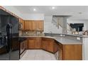 Updated kitchen featuring warm wood cabinets and stainless appliances at 1069 Thrill Ct # 102, Henderson, NV 89002