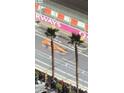Aerial view of F1 race on Las Vegas Grand Prix race course with palm trees at 135 E Harmon Ave # 2515, Las Vegas, NV 89109