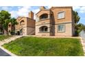 Inviting two-story apartment complex with neat landscaping, stairs to the units, and cozy balconies at 221 Mission Catalina Ln # 104, Las Vegas, NV 89107