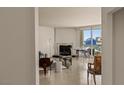 Open living room with a marble fireplace, floor to ceiling windows with captivating city views at 2877 Paradise Rd # 2502, Las Vegas, NV 89109