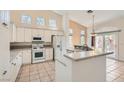 Bright kitchen features white cabinets, granite countertops, stainless steel appliances, and a breakfast bar at 2889 Anteres St, Las Vegas, NV 89117