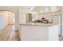 Bright kitchen features white cabinetry, stainless appliances, granite countertops, and an open floor plan at 2889 Anteres St, Las Vegas, NV 89117