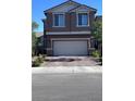 Two story home featuring a two car garage and a brick paved driveway at 3339 Cromford Dr, North Las Vegas, NV 89081