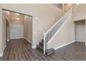 Inviting foyer with gray wood-look flooring, a high ceiling and a staircase with white railings at 4212 Hawks Glide Ave, North Las Vegas, NV 89084