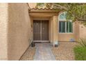 Close-up of the double front door framed by decorative trim and a security system at 4212 Hawks Glide Ave, North Las Vegas, NV 89084